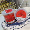 Two containers of Proven√ßal Fish Stew on a fishing-themed towel.