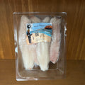Packaged fish fillets with a label on a wooden surface