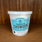 Container of Haddock Chowder on a wooden surface